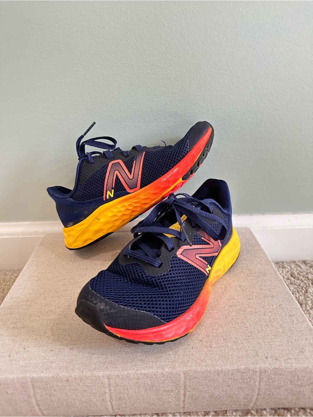 New Balance Kids Navy Shoes with Yellow and Red Accents